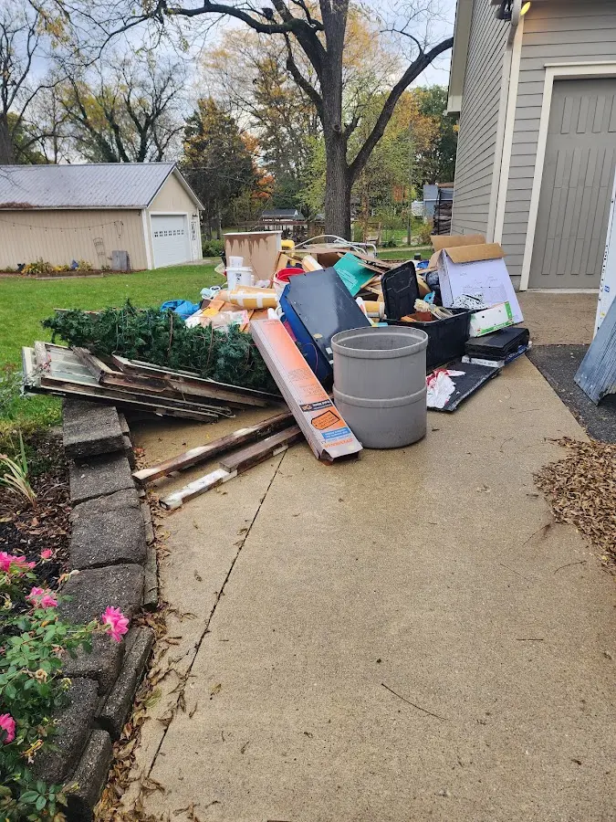Dumpster being loaded with debris for Commercial Dumpster Rental in Bryant